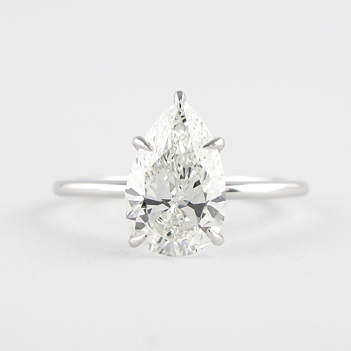 1.5 CT Pear Cut Solitaire Style Moissanite Engagement Ring